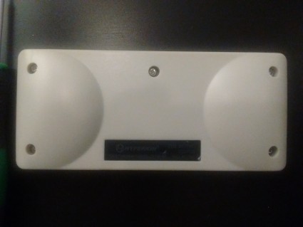 Unfortunately, there's a screw hidden under that Hyperkin label.