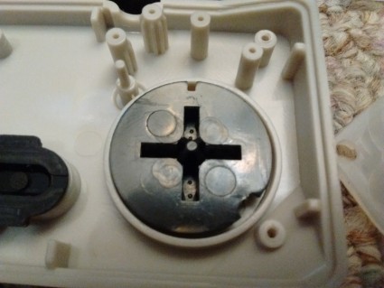 D-pad from the white Cadet controller, produced at least a few months earlier and purchased from Castlemania Games. Note the narrower, almost pointed pivot.