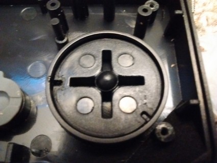 D-pad from the black Cadet controller. Note the extremely narrow pivot in the center.